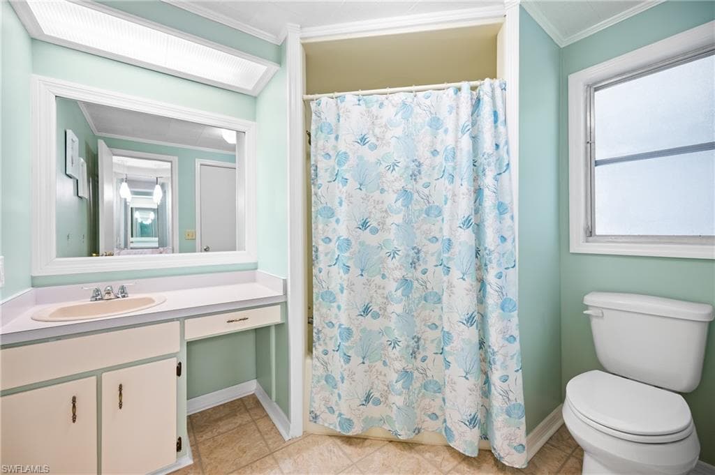 Bathroom vanity featuring a single sink, integrated countertop, and lower cabinetry