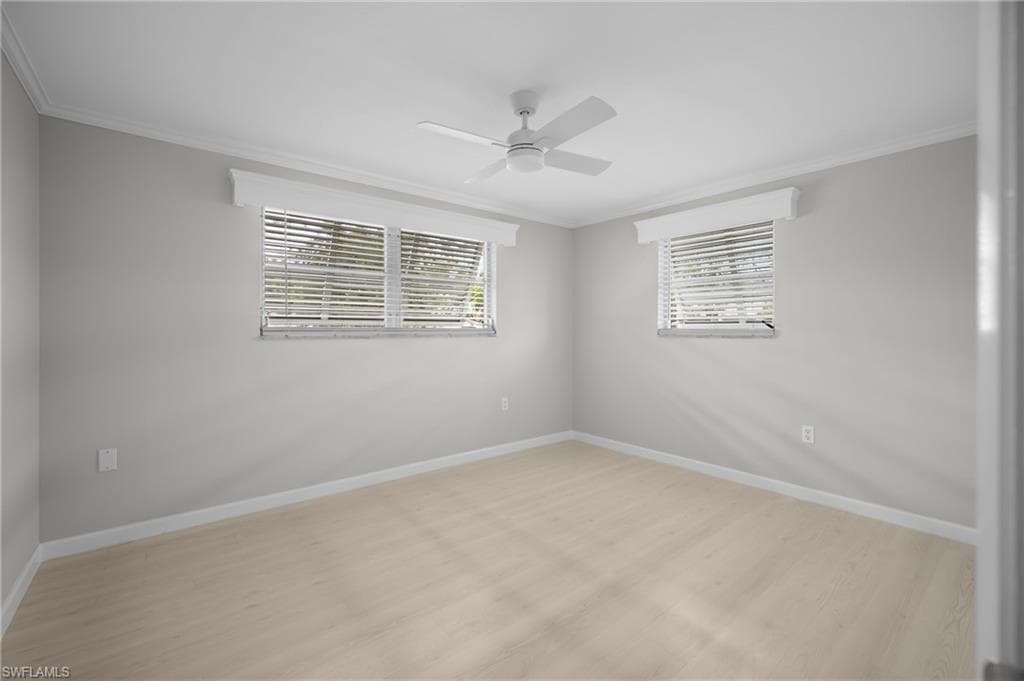 Light-colored wood-finish flooring complements the neutral wall tones