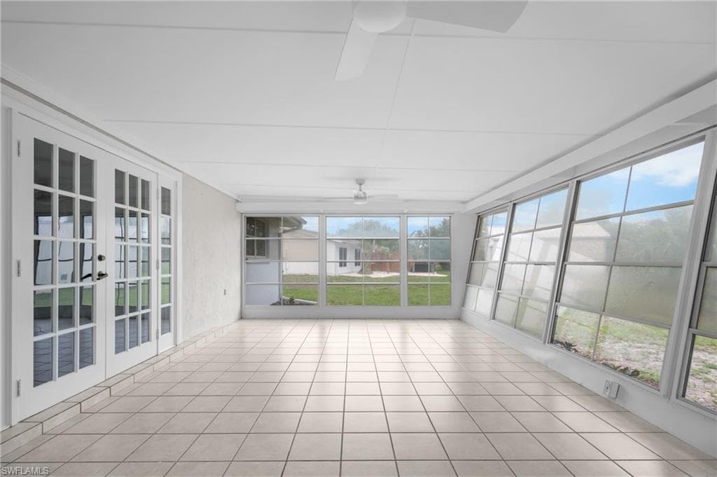 Spacious sunroom featuring tile flooring and full-height windows