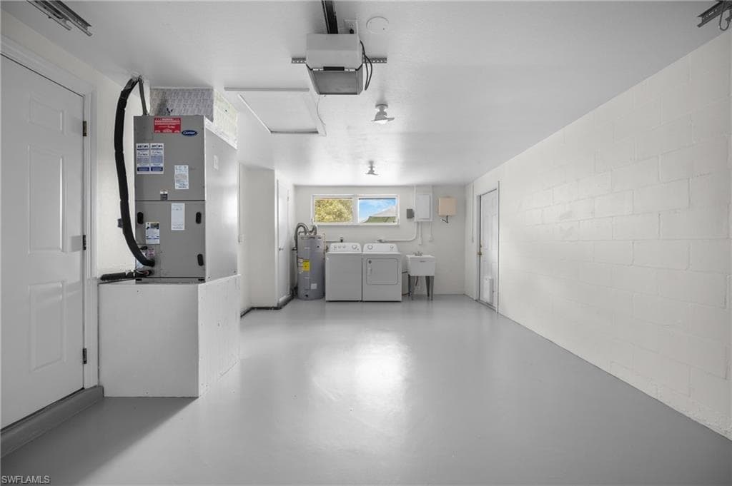 Spacious utility area featuring a window, built-in sink, and painted block walls