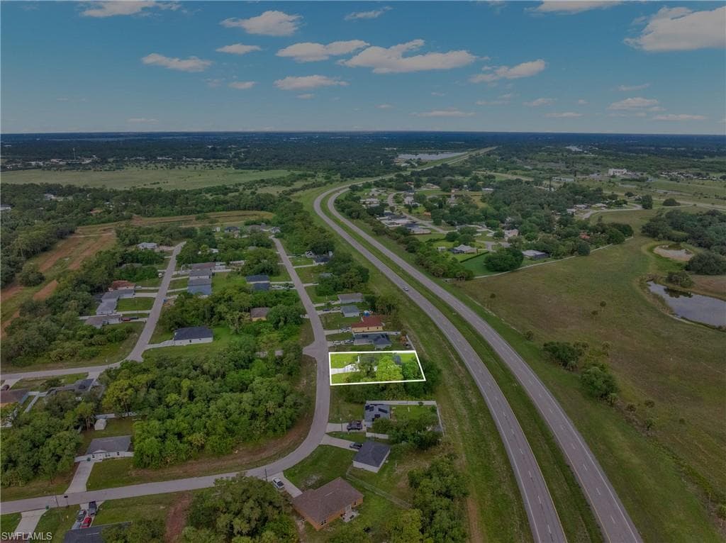 Aerial perspective showcasing a residential property with surrounding green spaces