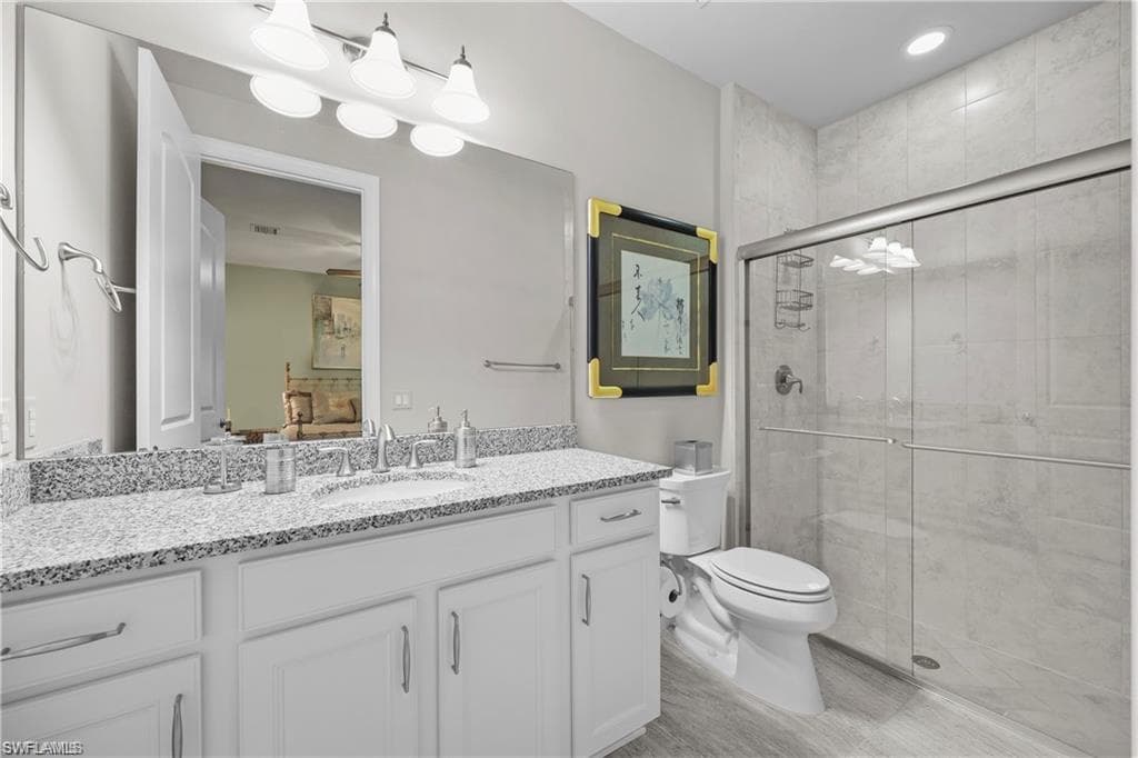 Bathroom featuring a shower stall and vanity