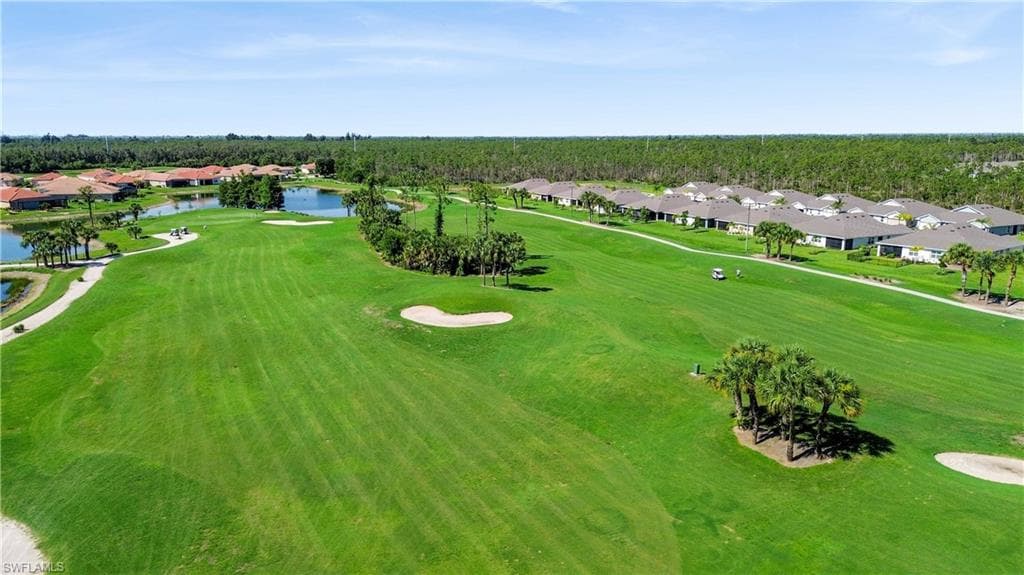 Expansive golf course featuring manicured fairways, sand traps, and mature palm trees