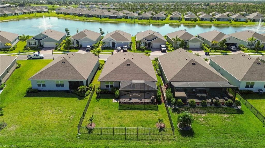 Expansive backyard featuring a screened patio and manicured lawn