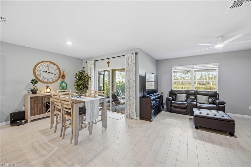 Bright living area featuring light-toned wood-finish flooring