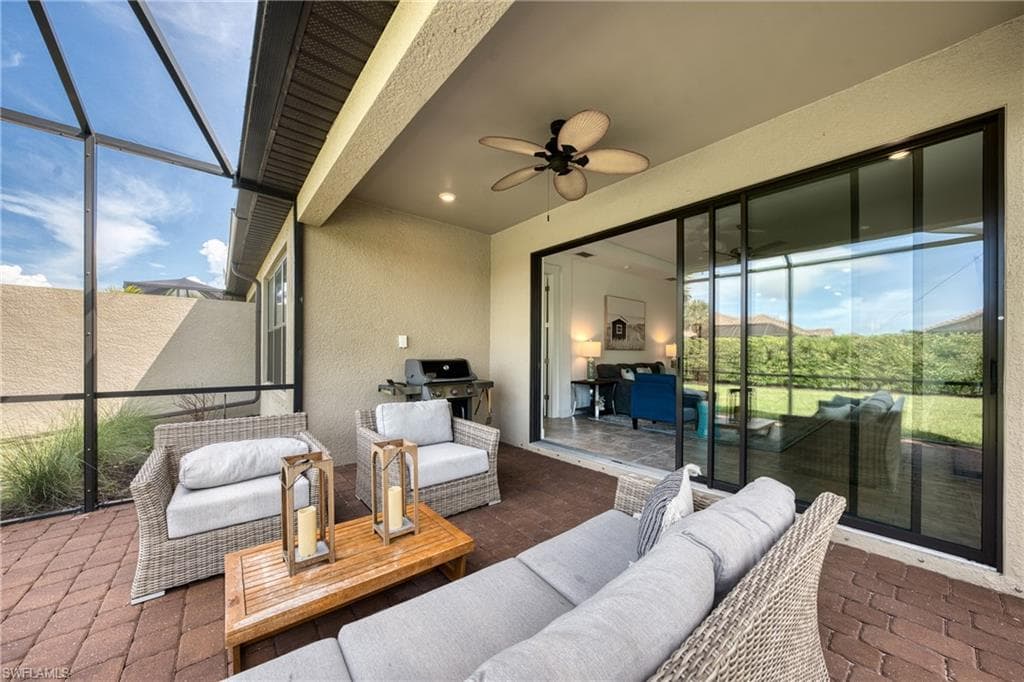Screened lanai featuring paver flooring, a ceiling fan, and recessed lighting