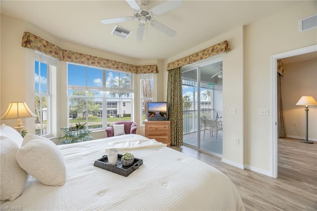 Retreat to the bright and inviting primary suite, where expansive windows fill the space with natural light. Featuring two walk-in closets and direct lanai access