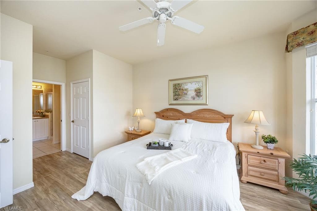 Retreat to the bright and inviting primary suite, where expansive windows fill the space with natural light. Featuring two walk-in closets and direct lanai access, this serene sanctuary overlooks the sparkling pool and tranquil water feature, creating the perfect setting to relax and unwind.