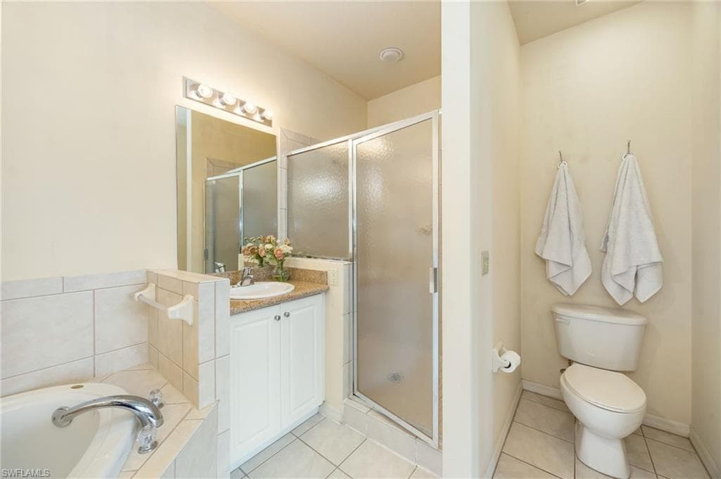 Primary bath with soaking tub, walk-in shower complete with dual vanities.