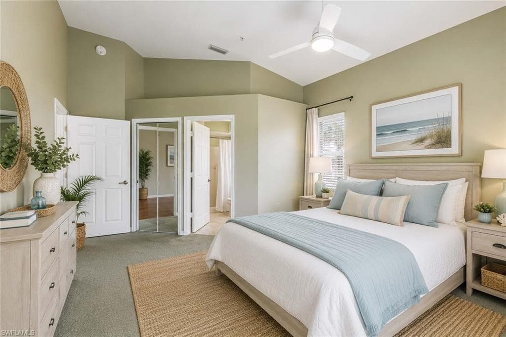 Virtually Staged Primary Bedroom featuring vaulted ceilings, a contemporary ceiling fan with integrated lighting, window blinds, and carpet flooring