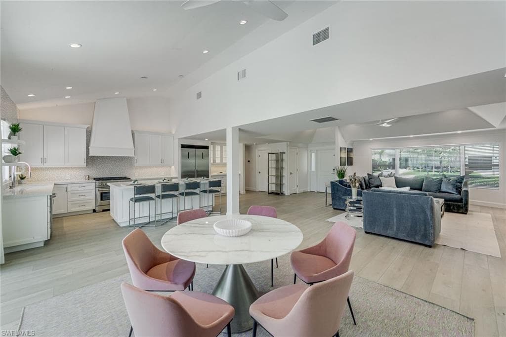 Bright, open-concept interior featuring light wood-finish flooring and recessed lighting