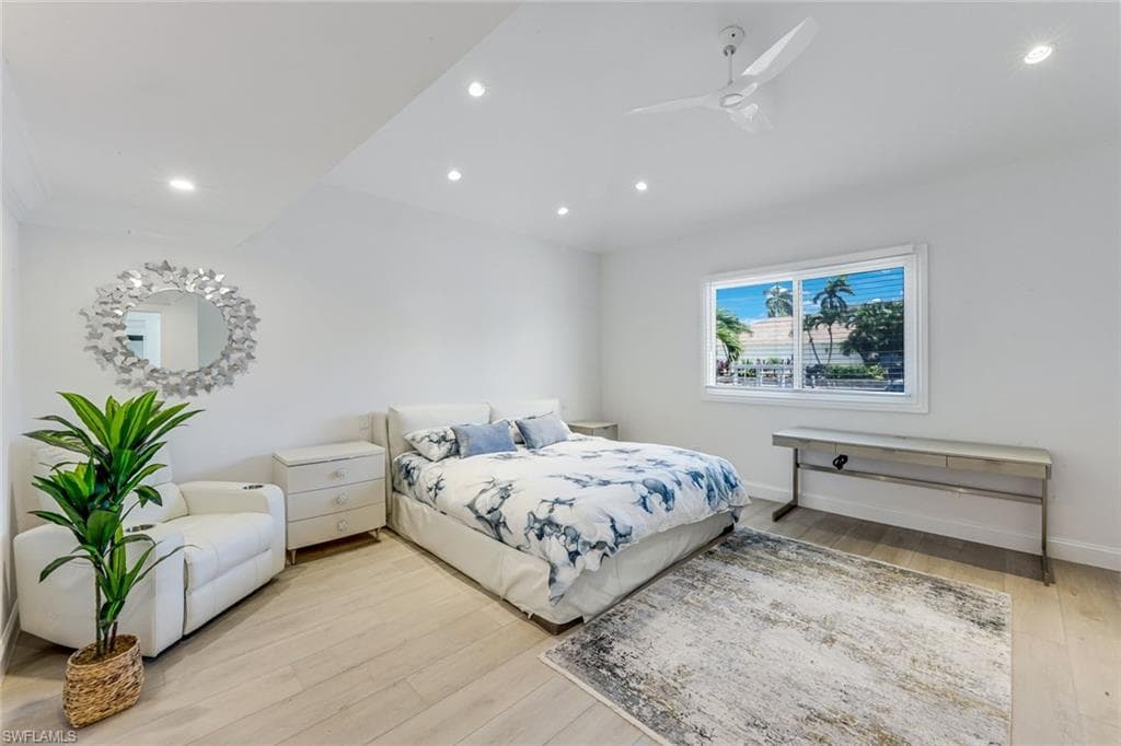 Primary Bedroom featuring wood-finish flooring, recessed lighting, a ceiling fan, and a large window with horizontal blinds