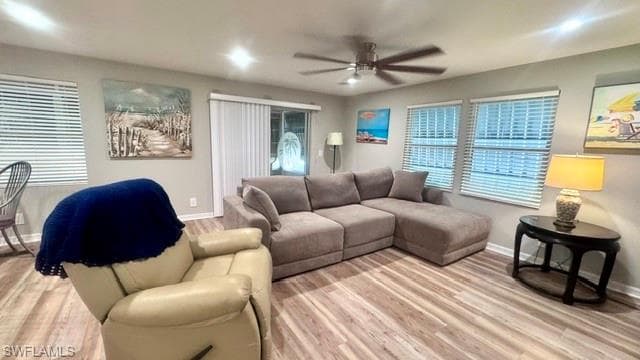 Living area featuring wood-finish flooring, recessed lighting, and a ceiling fan