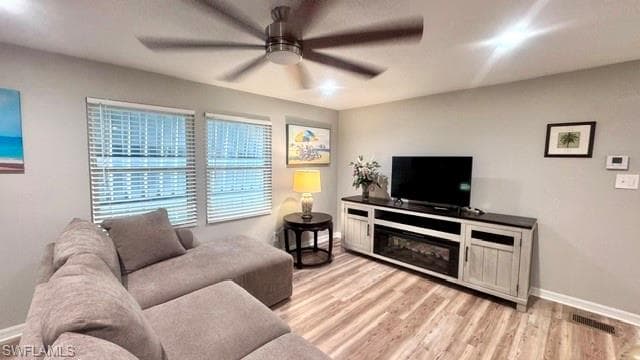 Light-toned wood-finish flooring complements the neutral wall color