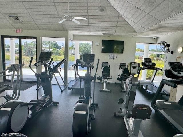 Fitness center featuring multiple exercise machines, a wall-mounted television, and ceiling fans