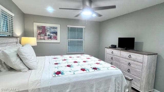 Light gray walls complementing the neutral ceiling fan with integrated lighting