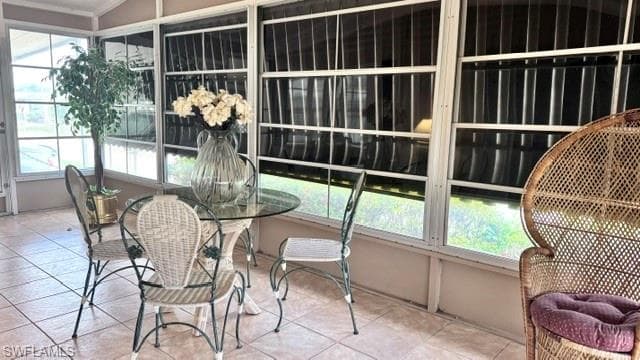 Enclosed sunroom featuring multiple large windows, screened panels, and ceramic tile flooring