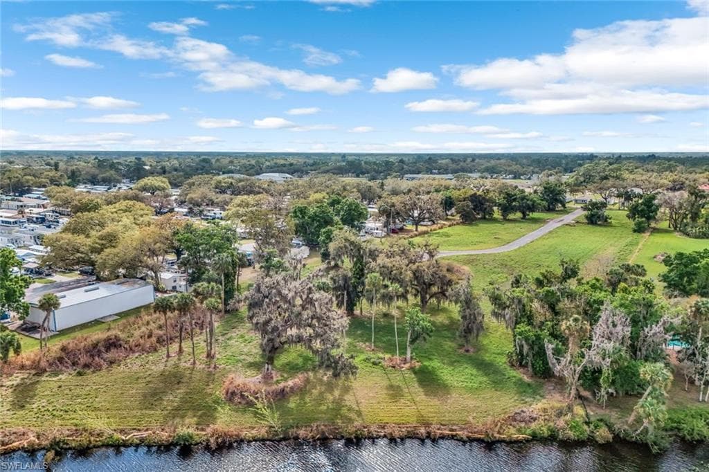 Birds eye view of property with a water view