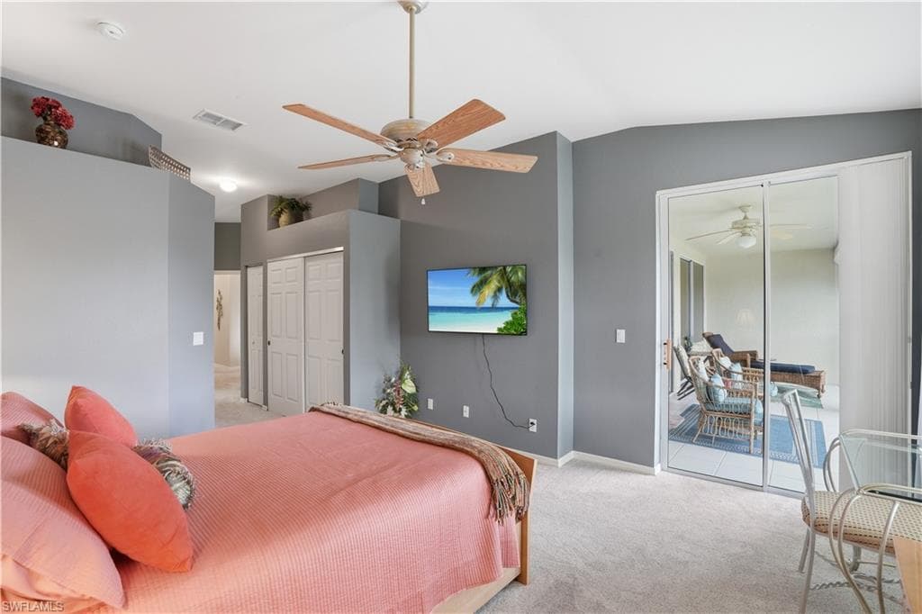 Primary bedroom with vaulted ceilings and access to the lanai.