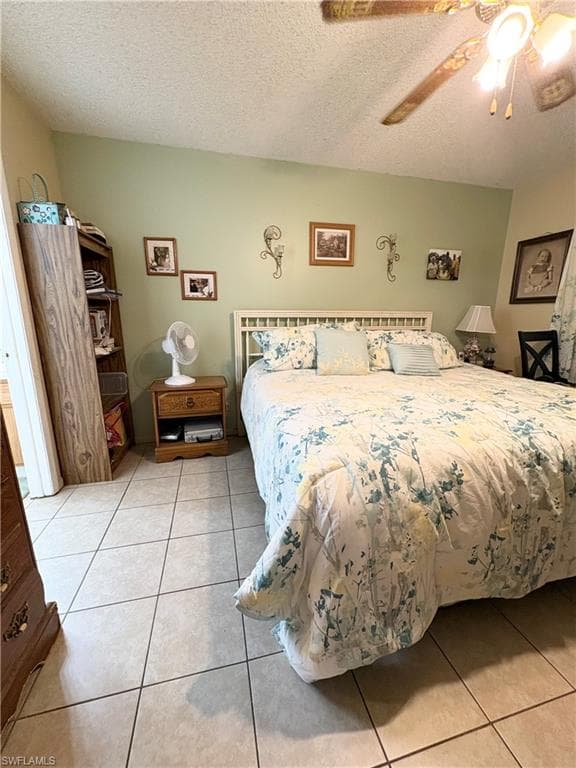 Bedroom featuring light tile flooring and a light green accent wall