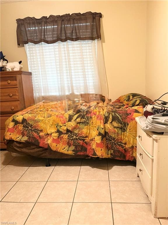Interior space featuring light-colored wall paint and square tile flooring