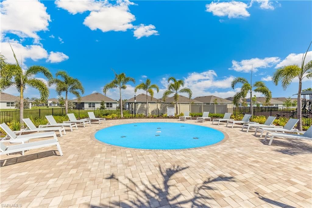 The property offers a circular splash pad surrounded by lounge chairs on a paver patio