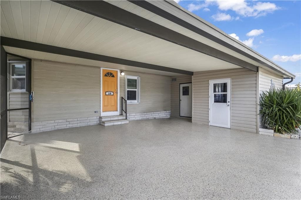 Spacious carport with 2-car space, workroom and laundry room with washer and dryer