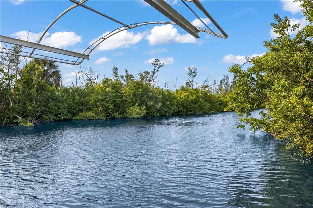 BEAUTIFULLY UPDATED, MOVE-IN-READY waterfront home offers the perfect combination of COASTAL CHARM, BOATING CONVENIENCE & RESORT-STYLE LIVING