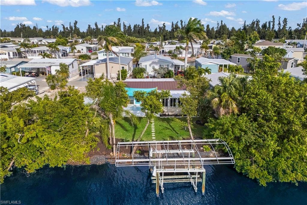 Situated on scenic canal, this 2 BED + 2 BATH manufactured HOME features PRIVATE DOCK & 10K-lb BOAT LIFT