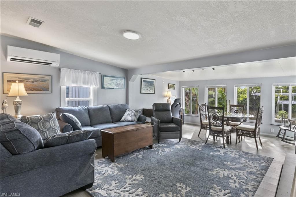 Inside, the bright & airy floor plan is filled w/ natural light, enhanced by expansive waterfront windows that frame peaceful canal views throughout the main living areas