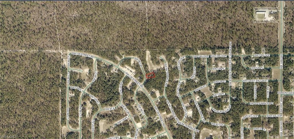 Aerial View Map. Displaying the property's location within a residential area and its surrounding natural environment
