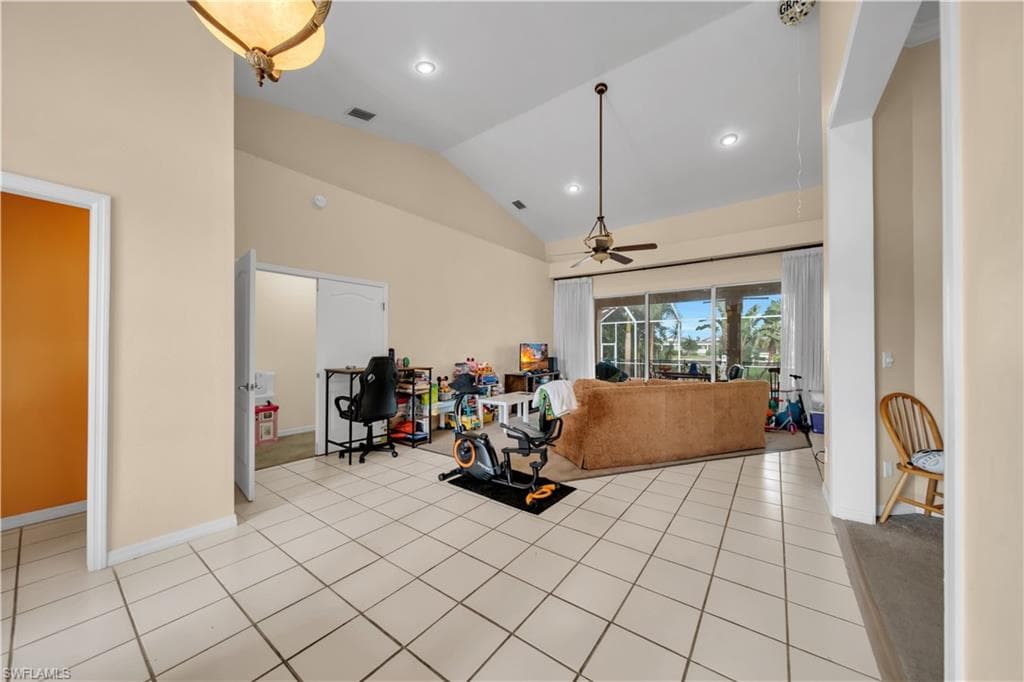 Open entry to the Great room with vaulted ceilings and large sliding doors