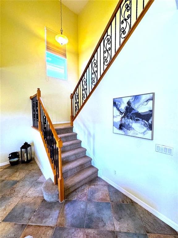 Staircase with a towering ceiling