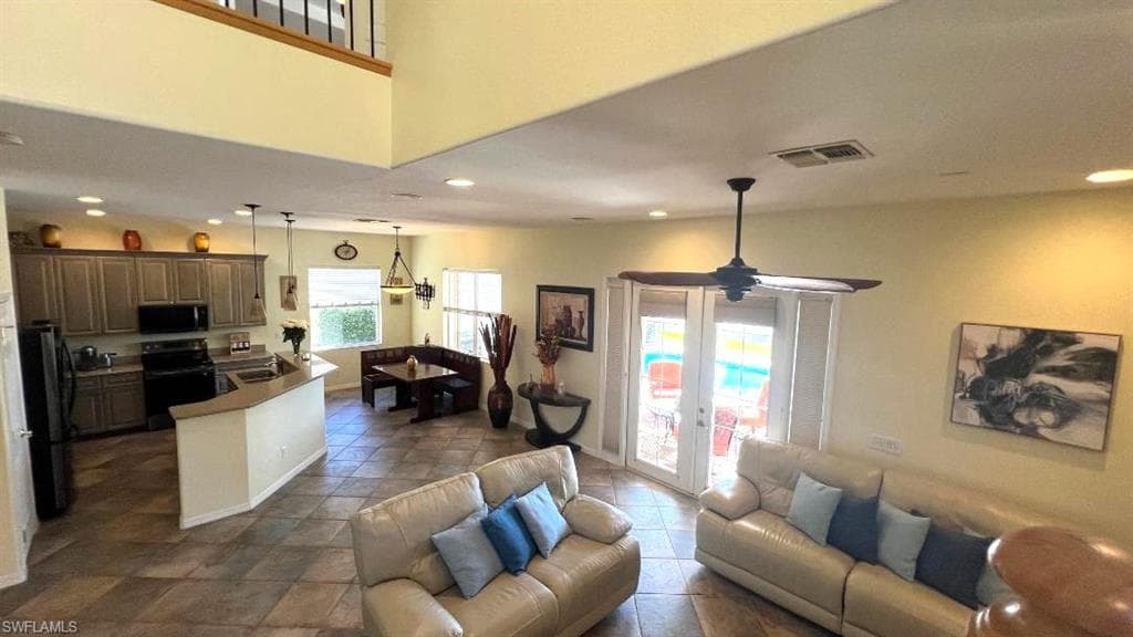 Living room featuring sink, ceiling fan, and french doors