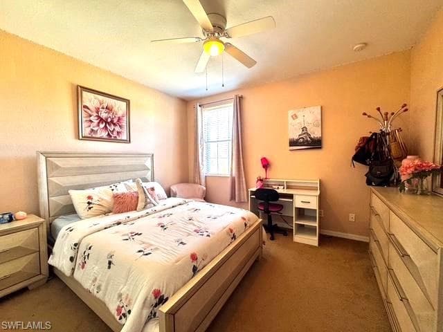 Carpeted bedroom with ceiling fan