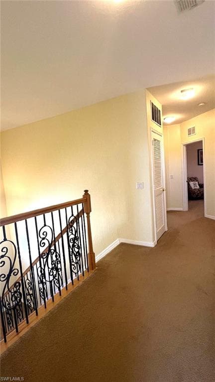 Hall featuring carpet flooring