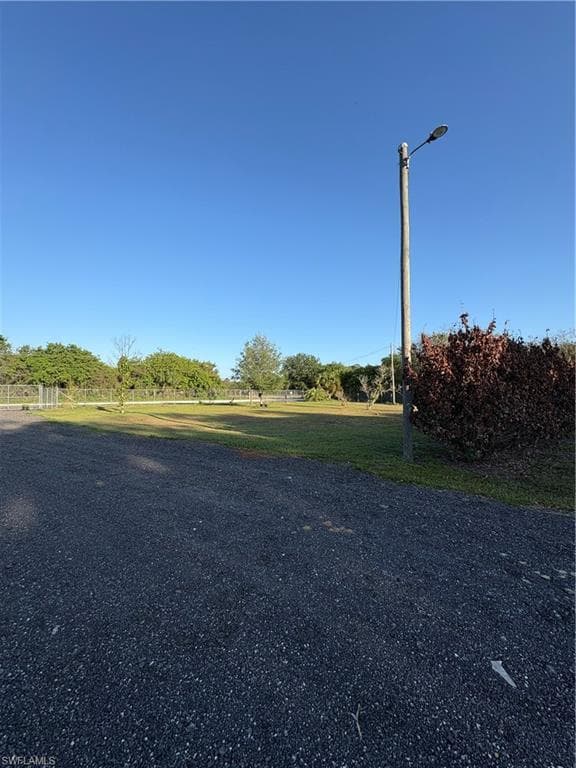Expansive gravel area with a prominent street lamp