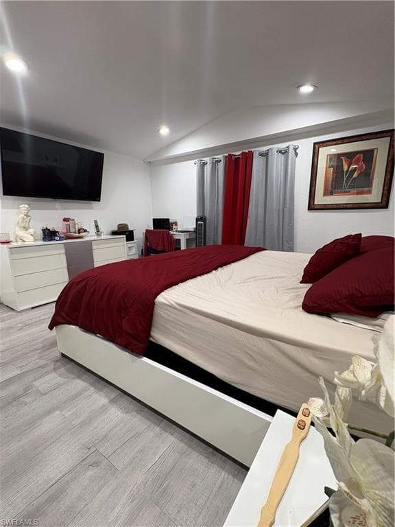 Recessed ceiling lighting, light wood-finish flooring, and white walls