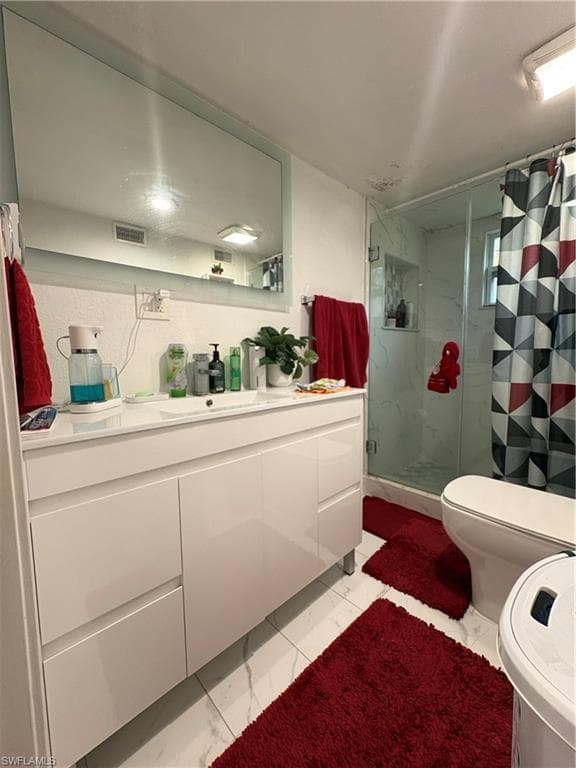 Contemporary bathroom featuring a white floating vanity with an integrated sink and a large rectangular mirror