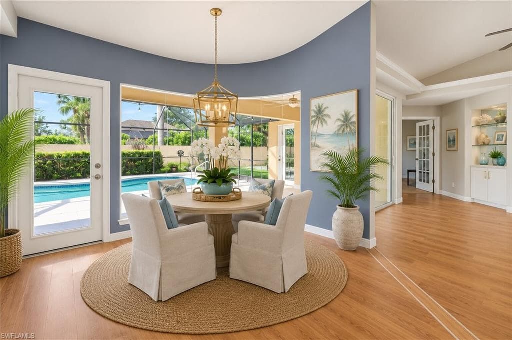 Breakfast nook off kitchen overlooking the pool. Property looks as it appears, furniture is ai generated.