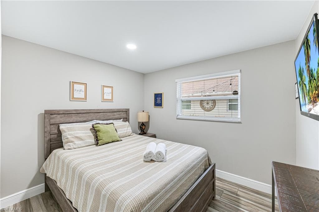 Bedroom featuring wood-type flooring
