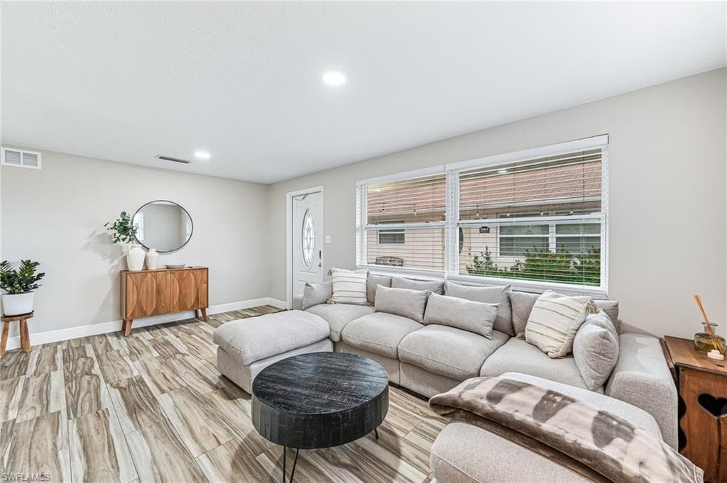 Living room with light hardwood / wood-style floors