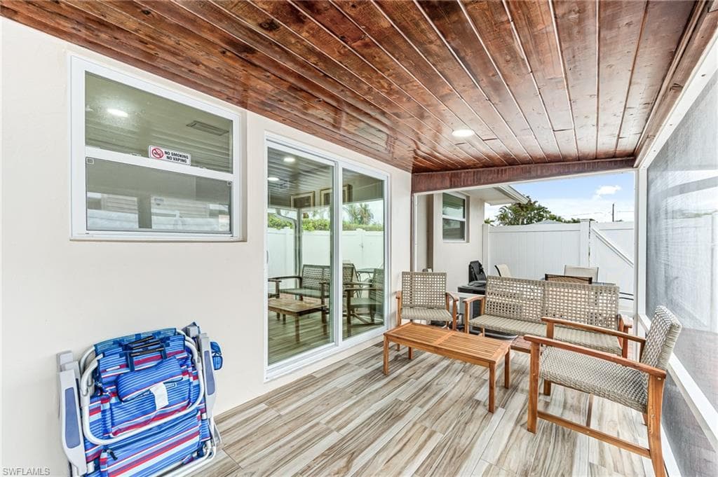 Sunroom / solarium with a healthy amount of sunlight and wooden ceiling