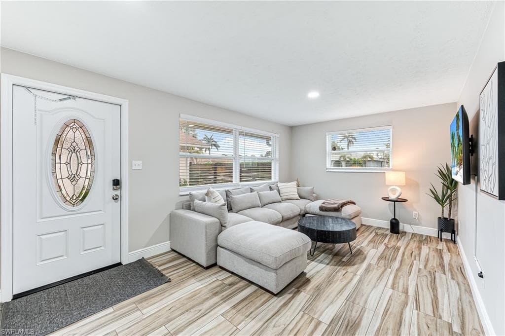 Living room with light wood tile floors throughout