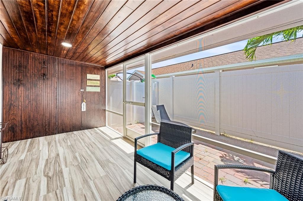Unfurnished sunroom featuring wood ceiling