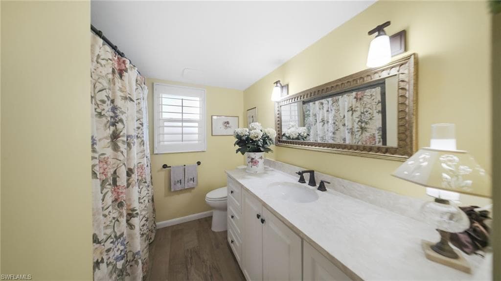 Convenient interior laundry room features side-by-side appliances, upper cabinetry, and additional storage space.