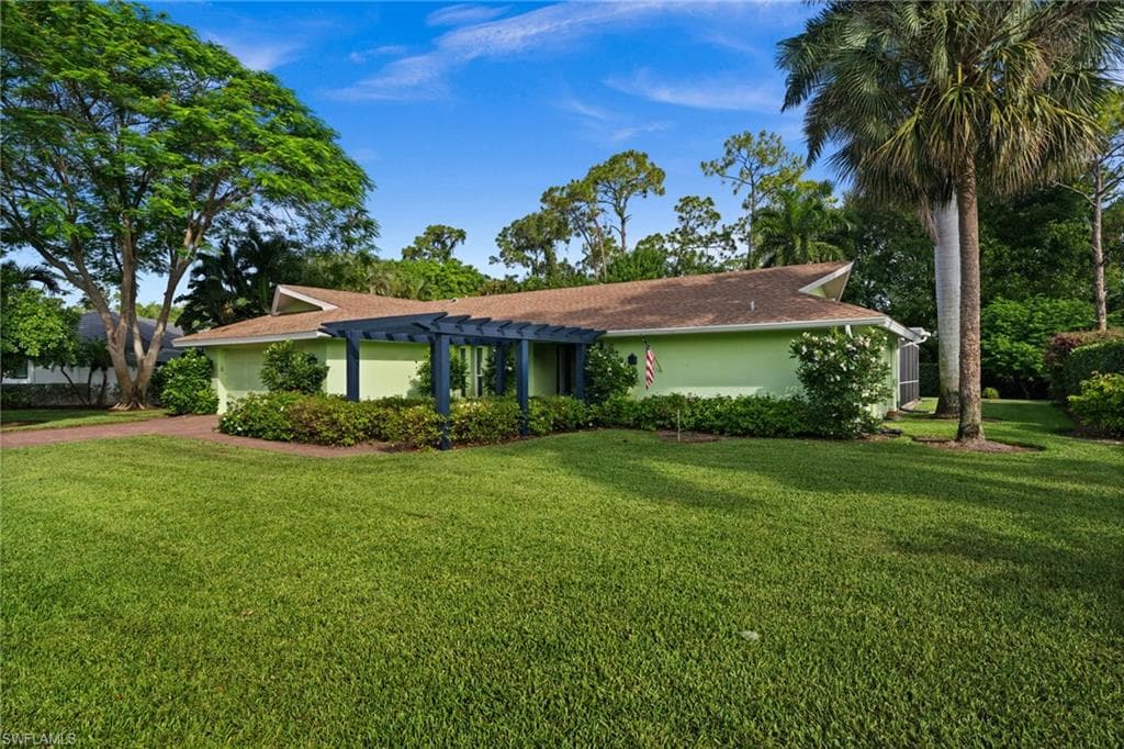 Lush landscaped walkway creates a welcoming approach to the home’s private entrance.