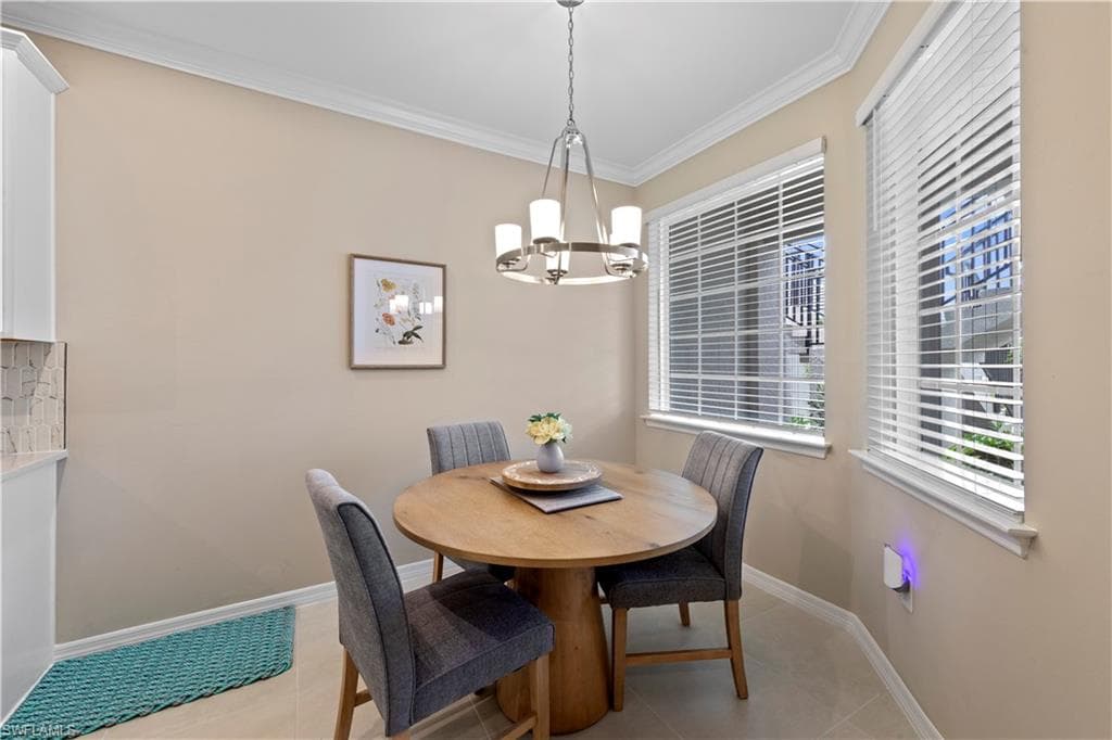 Featuring two large windows with white blinds, a contemporary chandelier, crown molding, and neutral wall tones