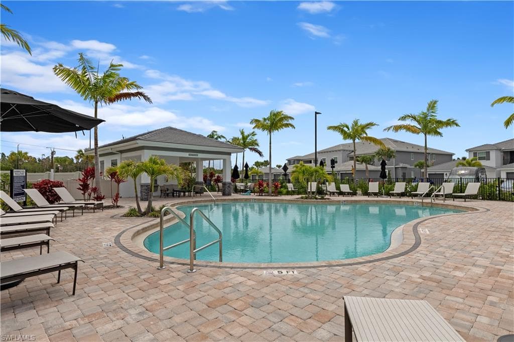 Resort-style pool with a curvilinear design, surrounded paver decking