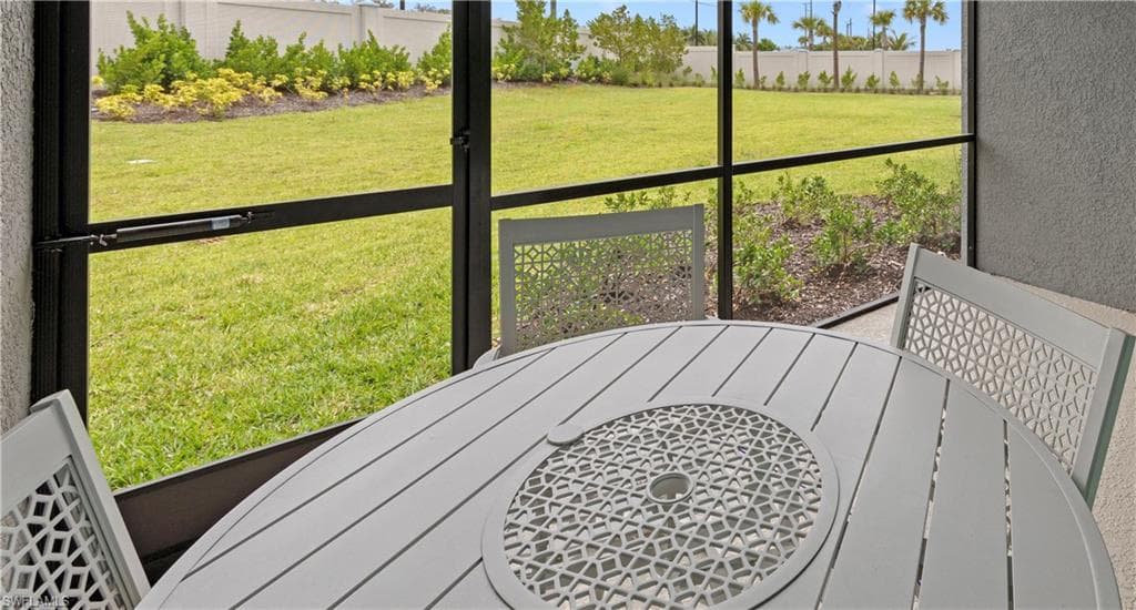 Screened outdoor living space featuring textured exterior walls and a concrete patio